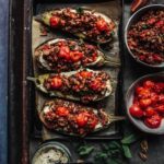 Baked aubergine with lentil salad, creamy hummus & roast tomatoes