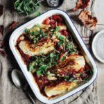 Baked hispi cabbage in smoky tomatoes and tahini
