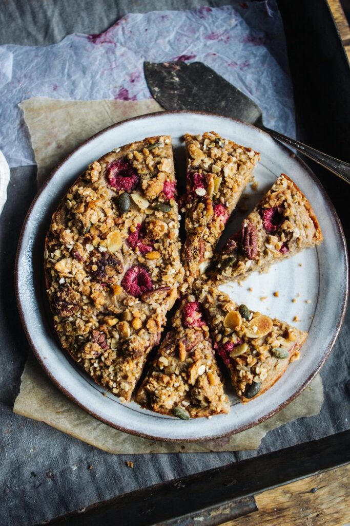 Banana, almond and raspberry cake with granola topping