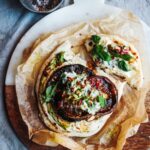 Griddled harissa mushrooms on fluffy flatbread with smoky butter bean hummus and mint dip