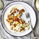 Cauliflower, parsnip and roast garlic puree with crispy​ roast potatoes and fennel slaw