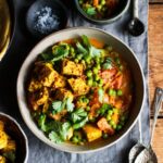 Pea & tomato curry with spiced tofu & flatbreads