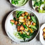 Roast potato salad with broad bean, pea and pistachio cream