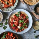 Smoky sweet potato, red pepper & chickpea stew with sweet potato wedges, creamy hummus & toasted seeds