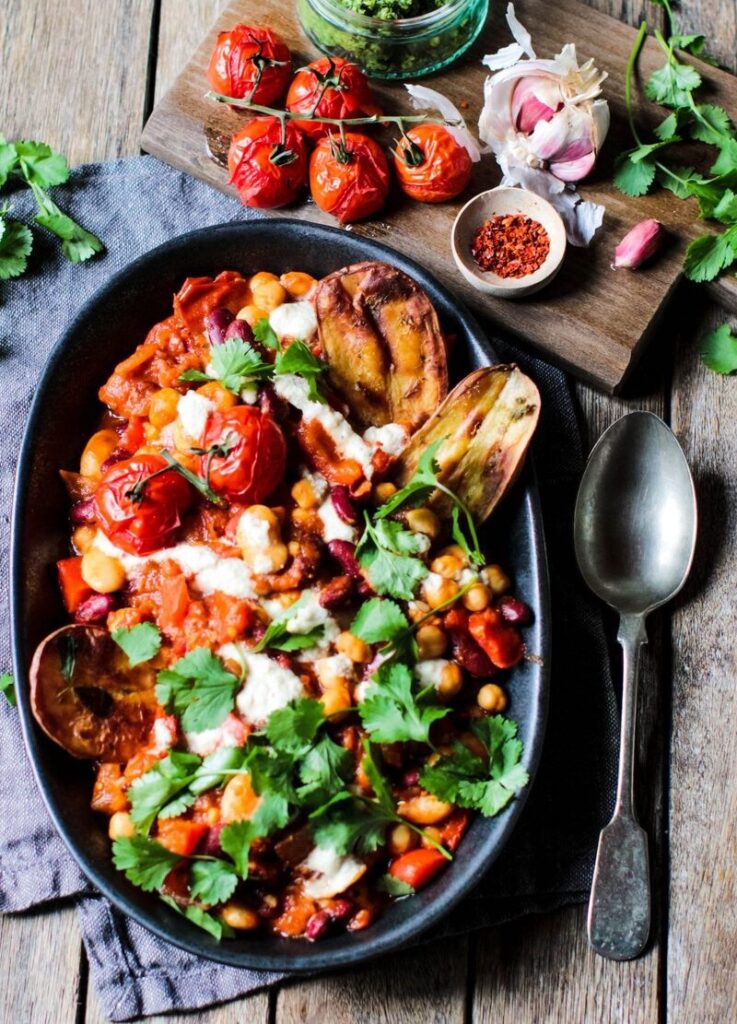 Spicy beans with creamy cashew cheese sauce and crispy potato wedges