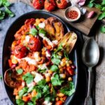 Spicy beans with creamy cashew cheese sauce and crispy potato wedges