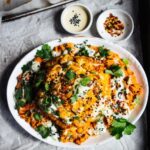 Whole roast cauliflower with smoky tomato sauce, chickpeas and cucumber mint dressing