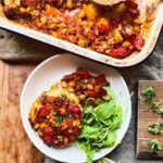 Baked mushrooms in a rich tomato sauce, cashew cheese and chickpeas