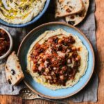 Harissa chickpeas with sticky leeks and fluffy harissa hummus with za'atar