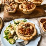 Mini vegan 'cheese' tarts with sprout and walnut slaw